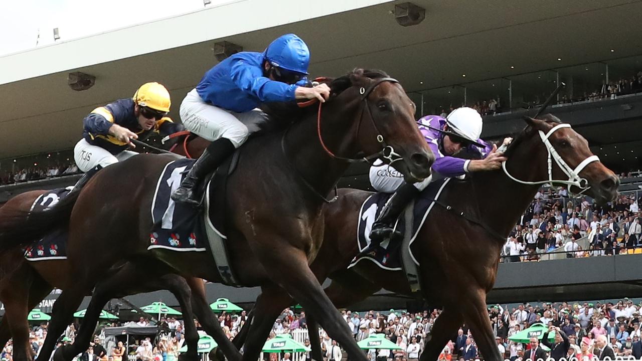 Broadsiding (blue silks) holds on to win the Rosehill Guineas from a late-charging Aeliana. Picture: Getty Images