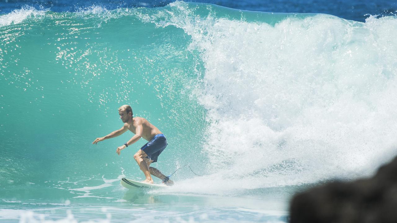 A surfer taking on a large wave at Point Perry in the Sunshine Coast as swell from Cyclone Oma begins to arrive. Picture: Lachie Millard