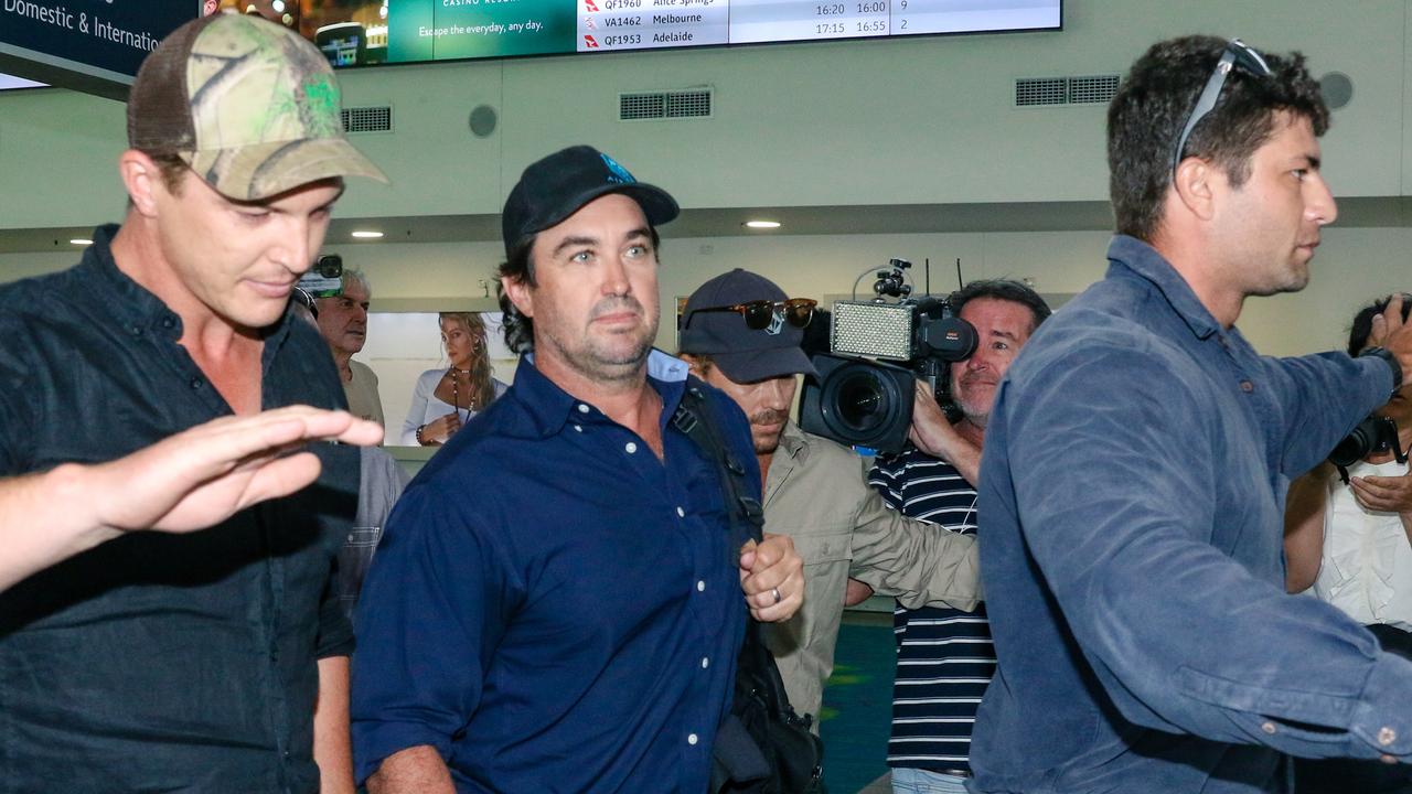 Matt Wright arrives in Darwin flanked by security to present himself to NT Police to face charges relating to the fatal chopper crash that killed his friend and co-star Chris ‘Willow’ Wilson in February 2022. Picture: Glenn Campbell