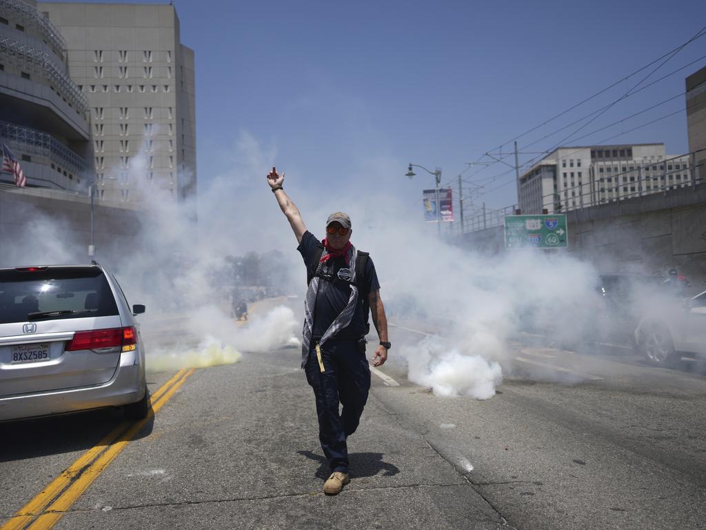 A protester defies orders as tear gas is used. Picture: AP