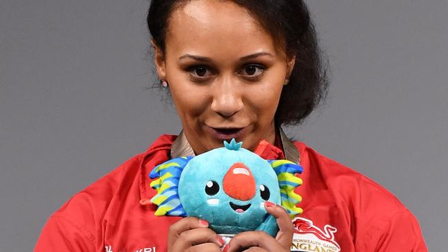 Silver medallist Zoe Smith of England kisses the 2018 Gold Coast Commonwealth Games mascot Borobi after the women's 63kg weightlifting. The mascot has generated more than $3.6 million in sales. Picture: AFP/William West