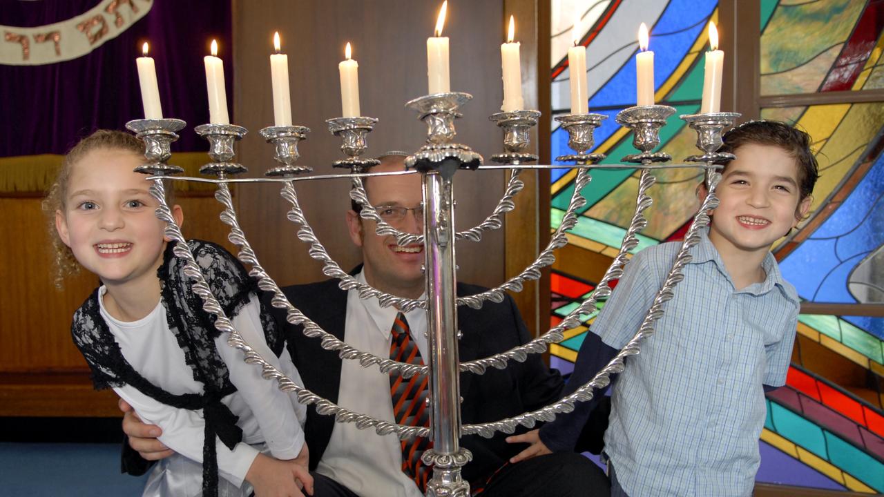 Children lighting candles for Hanukkah. Picture: Danielle Butters