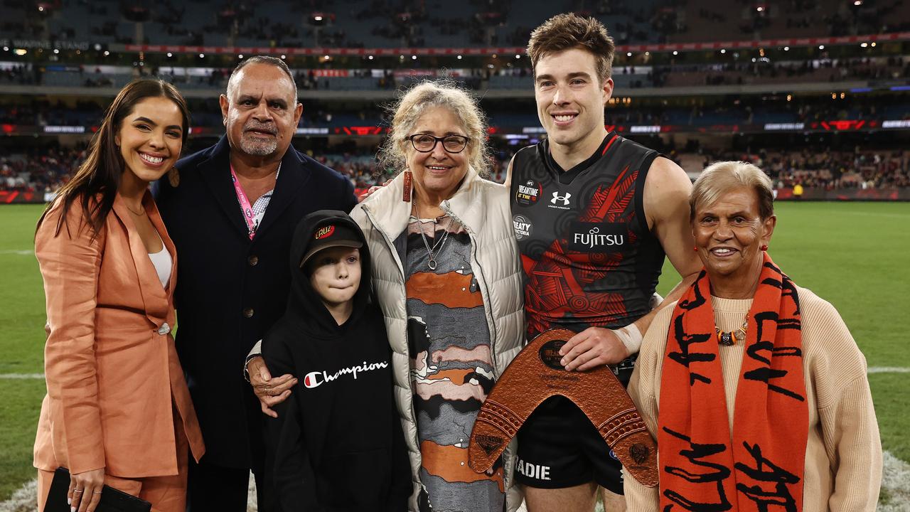 Zach Merrett of the Bombers with Michael Long and Aunty Joy Murphy Wandin. Pic: Michael Klein.