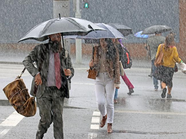 SYDNEY, AUSTRALIA - NewsWire Photos OCTOBER 06, 2022: Commuters are pictured near Central Station as Sydneysiders battle wild wet and windy weather and the Australian east coast is battered with storm weather. Picture: NCA NewsWire / Nicholas Eagar