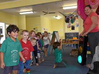 GREEN SAYS GO: Leesa Beasley with Eidsvold Kindy's new traffic light. Picture: Alex Treacy