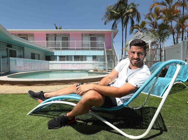 6/12/2019: Swiss tourist Damian Unger, 27, lounging by the pool at the Ventura Beach Motel on the Gold Coast. Damian met the developers of this lovely retro Palm Springs style motel while overseas and travelled to the Gold Coast  to stay. Lyndon Mechielsen/The Australian