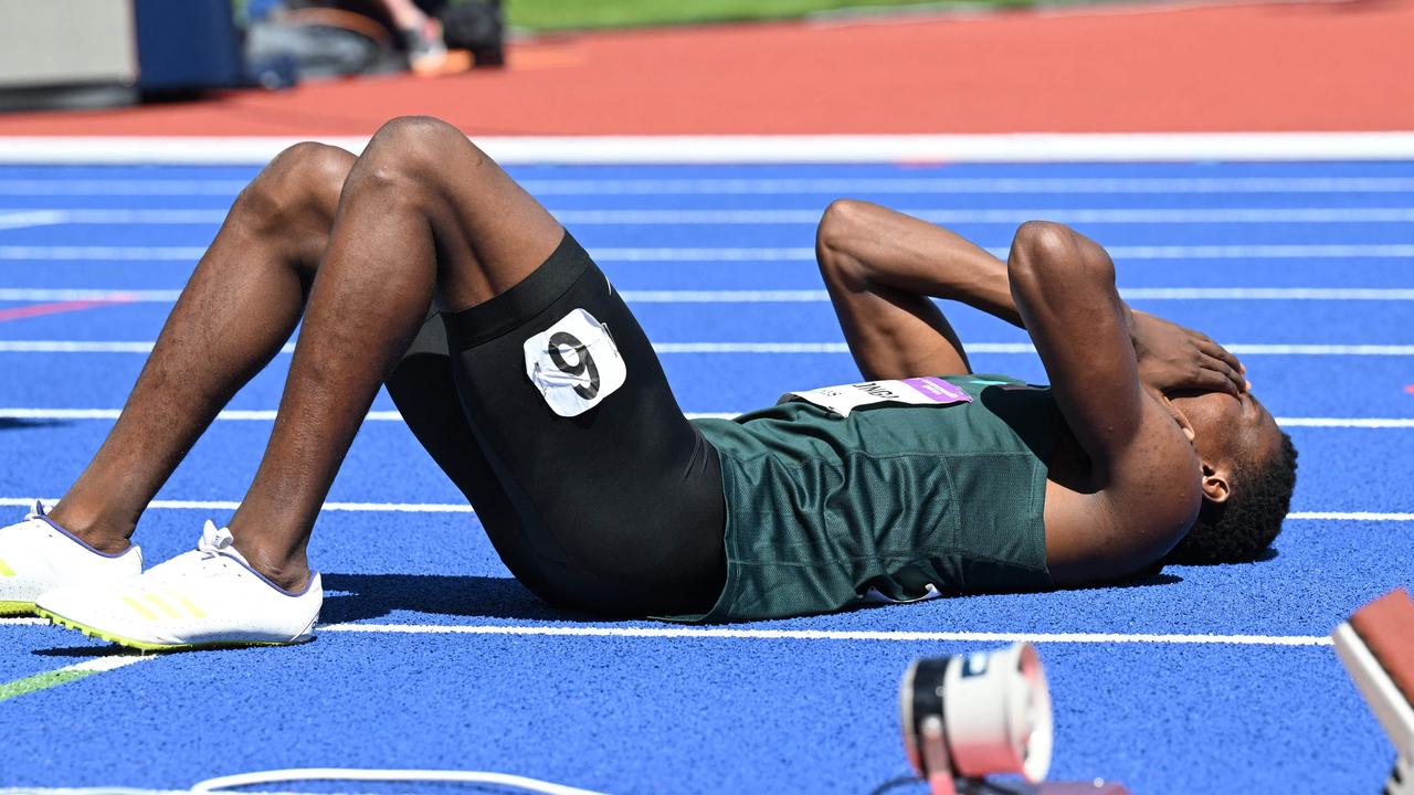 Zambia's Muzala Samukonga collapses after hitting the line. Photo by Andy Buchanan / AFP.