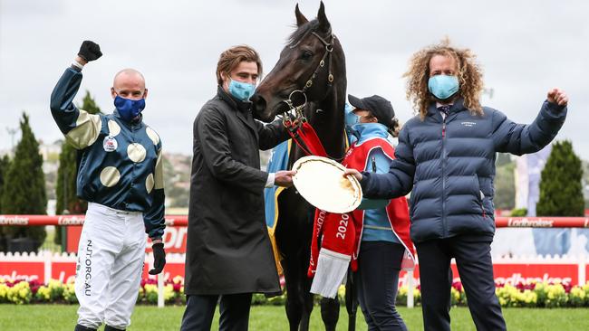 Boss with Sir Dragonet’s co-trainers and the Cox Plate. Picture: Getty Images