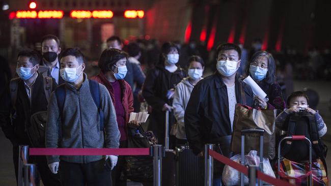 Passengers line up to enter Wuchang railway station in Wuhan.