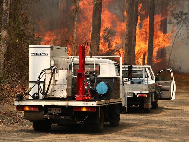 Firefighters battle bushfires in Busbys Flat, northern NSW, Wednesday, October 9, 2019. (AAP Image/Jason O'Brien)