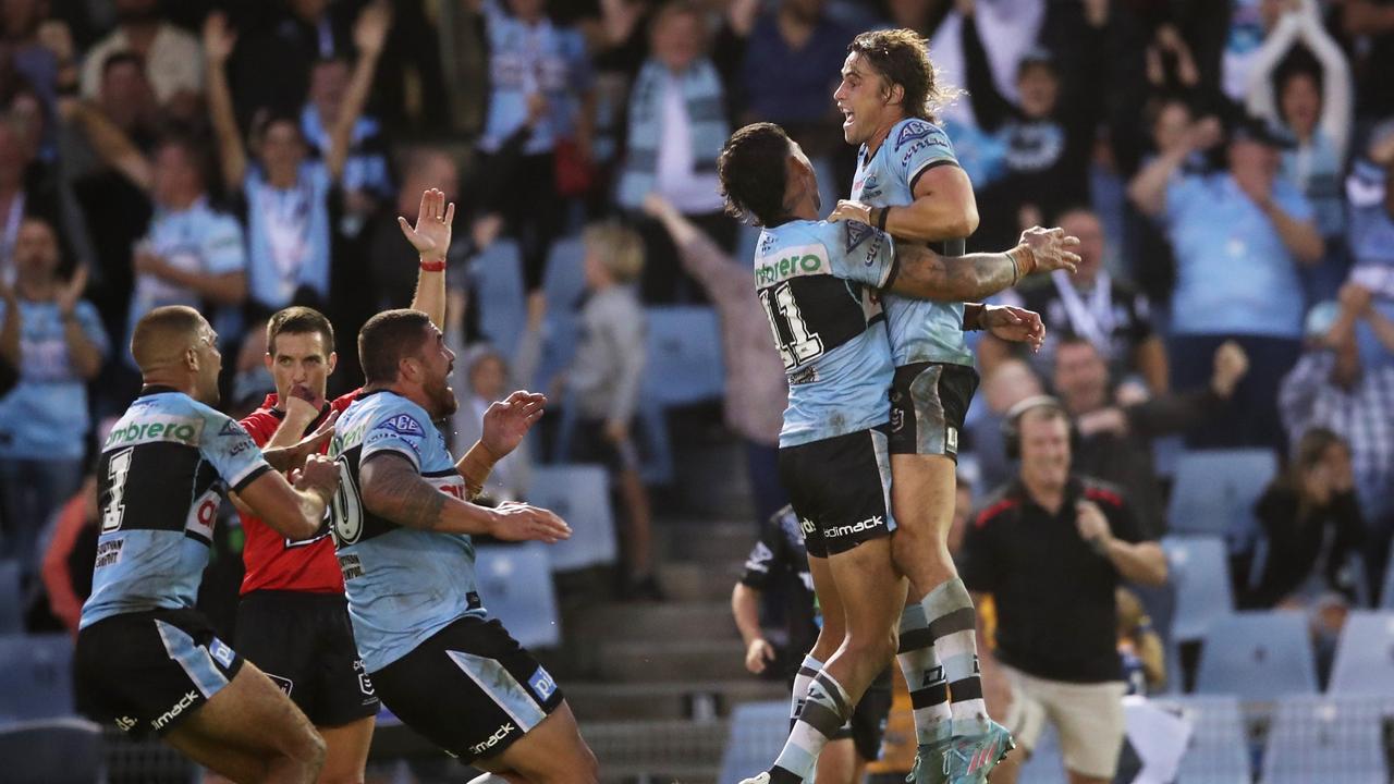 Nicho Hynes is swamped by his teammates after kicking the match-winning goal for the Sharkjs against the Eels. Picture: Matt King/Getty Images