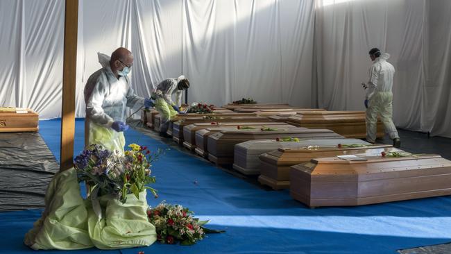 Coffins wait to be transported by the Italian Army to be cremated in Florence in 2020 in the village of Ponte San Pietro near Bergamo, Italy. Picture: Getty