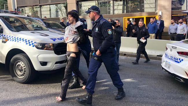 Police lead Ney away. Picture: 7 News