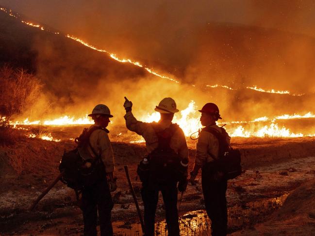 Fire crews battle the Kenneth Fire in the West Hills section of Los Angeles, Thursday, Jan. 9, 2025. (AP Photo/Ethan Swope)