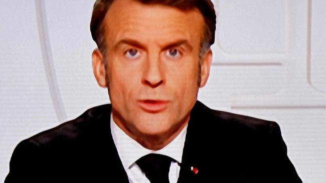 This photograph taken on March 5, 2025, shows a television screen broadcasting France's President Emmanuel Macron addressing a live interview on French TV at the Elysee Presidential Palace in Paris. Emmanuel Macron announced on March 5, 2025, that France will gather next week in Paris the chiefs of staff from countries ready to guarantee a future peace in Ukraine. (Photo by Ludovic MARIN / AFP)