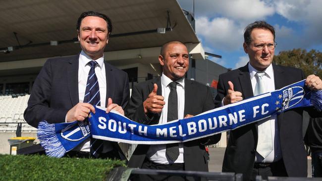 Brazilian legend Roberto Carlos (centre) with South Melbourne A-League chairman Bill Papastergiadis (left) and current club president Leo Athanasakis at Lakeside Stadium in May.