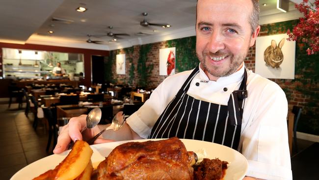 Hellenika at Nobby Beach is famous for its slow cooked lamb. Head chef Bryan Kelly with the lamb. Picture: Mike Batterham