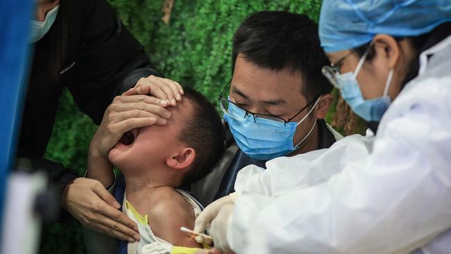 A child receives a Covid-19 coronavirus vaccine in Wuhan, in China's central Hubei province. Picture: AFP.