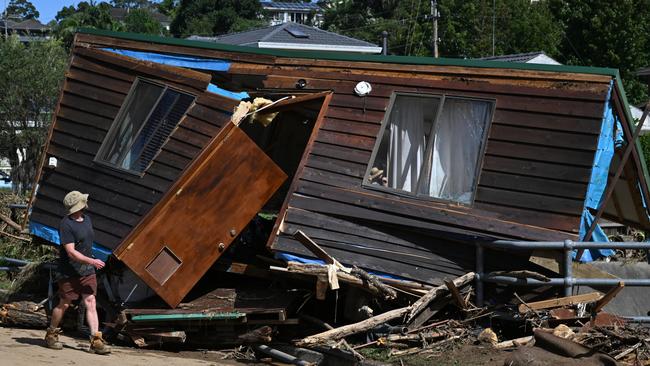 Two guests inside this Airbnb miraculously survived when it was washed off its foundations into a bridge. Picture: Dean Lewins