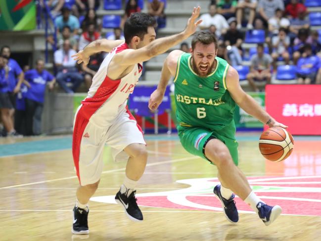 Australia's Mitchell Norton charges against Iran during their 2017 FIBA Asia Cup final basketball match, in the Lebanese town of Zouk Mikael north of Beirut on August 20, 2017. / AFP PHOTO / STR