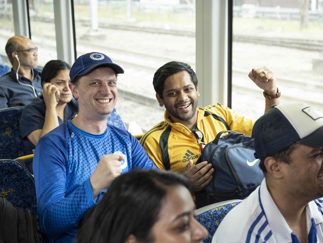 Tim Judge and Ani Shinde pictured cheering on the train to the SCG for the first day of the Pink Test. Picture: Monique Harmer