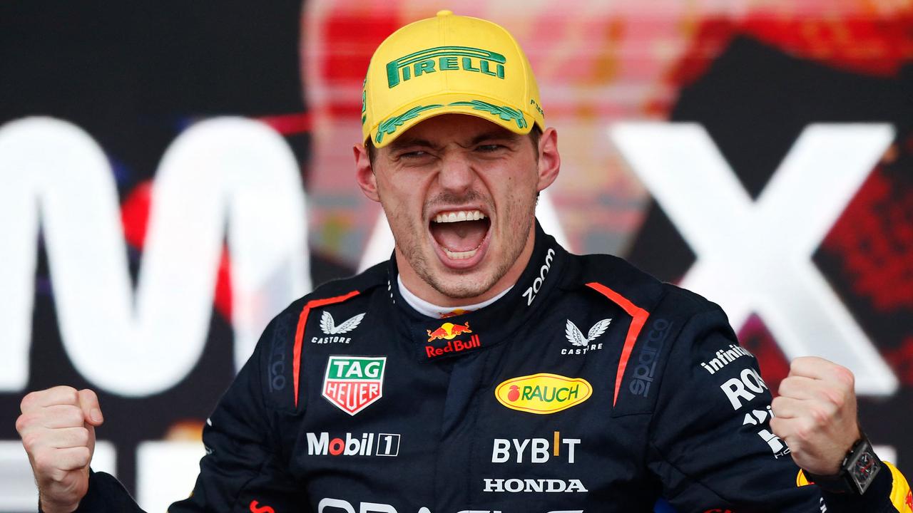 Max Verstappen celebrates winning the Brazilian Grand Prix. (Photo by Miguel Schincariol / AFP)