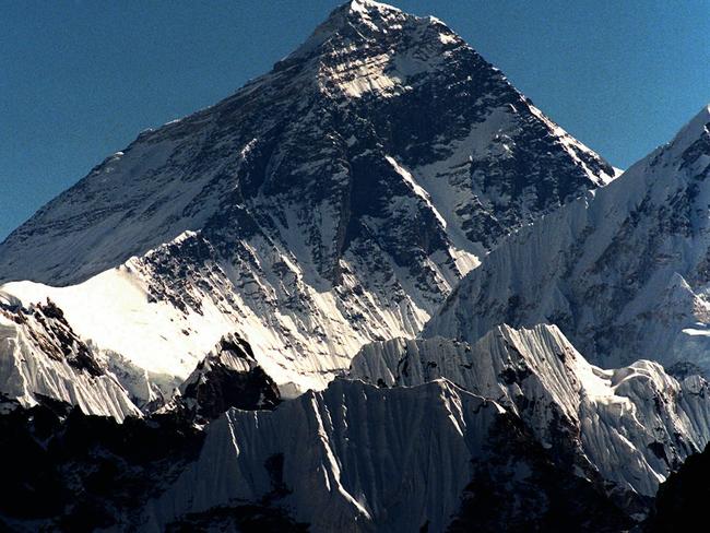 FILE - In this October 1996 file photo, Mount Everest is seen from peak Gokyo Ri in Nepal. Chinese state-run mobile news site The Paper reported Wednesday, May 11, 2016, that workers had removed the signatures, dates, doodles and messages left by scores of visitors on two granite tablets on the Chinese side of Mount Everest's northern base camp and plan to name and shame future defilers.(AP Photo/Hans Edinger)