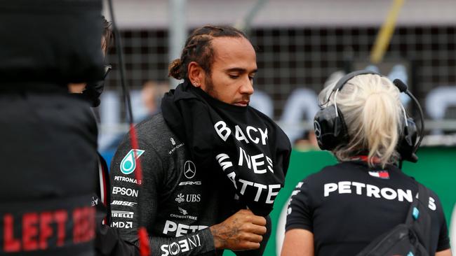 Hamilton puts on a shirt as part of the protest. Picture: AFP