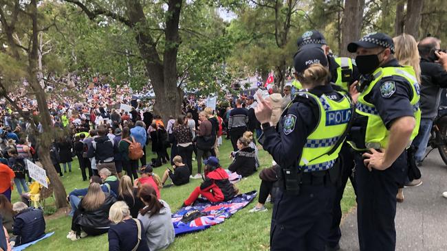 Mask-wearing police look on. Picture Keryn Stevens