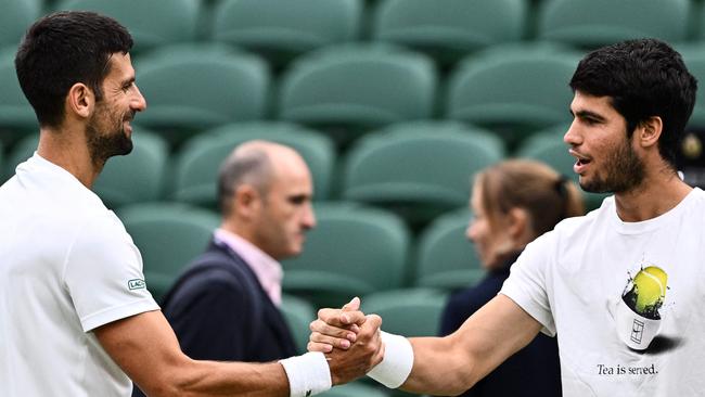 Serbia's Novak Djokovic and Spain's Carlos Alcaraz shake hands during a practice session prior to their semi-finals. Picture: AFP