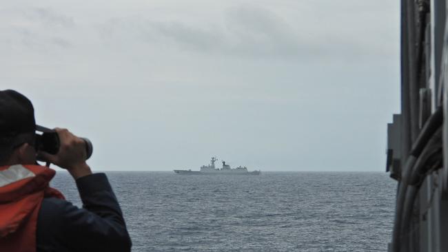 A Taiwanese navy sailor monitors a Chinese navy warship at sea this month. Picture: Taiwan's Ministry of National Defence/AFP