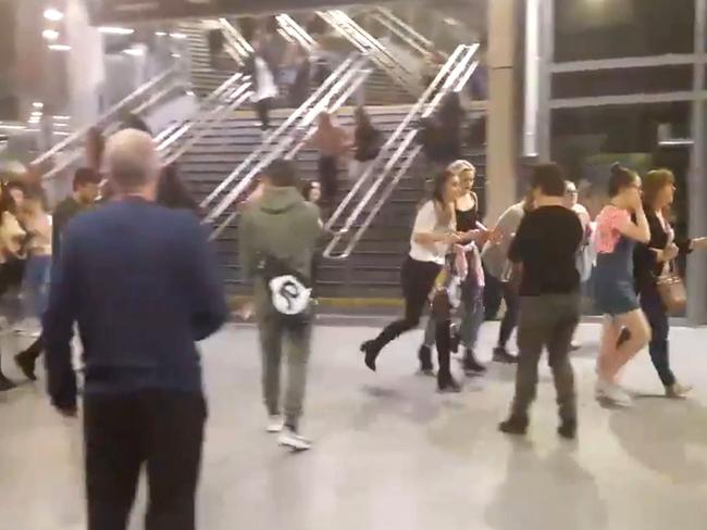 People running through Manchester’s Victoria railway station after an explosion at Manchester Arena. Picture: Zach Bruce/PA via AP