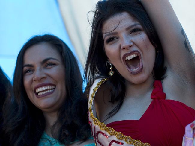 Inmate Mayana Rosa Alves, center, celebrates winning her jail's annual beauty contest at Talavera Bruce penitentiary in Rio de Janeiro, Brazil, early Thursday, Nov. 23, 2017. â€œEveryone is very happy to be with their family. I feel nervous and at the same time happy. I just wish I had also won freedom and would have taken my sash with me out of here,â€ said Alves who is serving time for robbery. (AP Photo/Silvia Izquierdo)