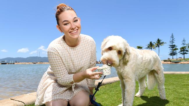 Rockpool Pavilion Venue Manager Tayla Hancock treats 1yo cobber dog, Cyril, to some Doggie Ice cream which they now stock. Picture: Shae Beplate.