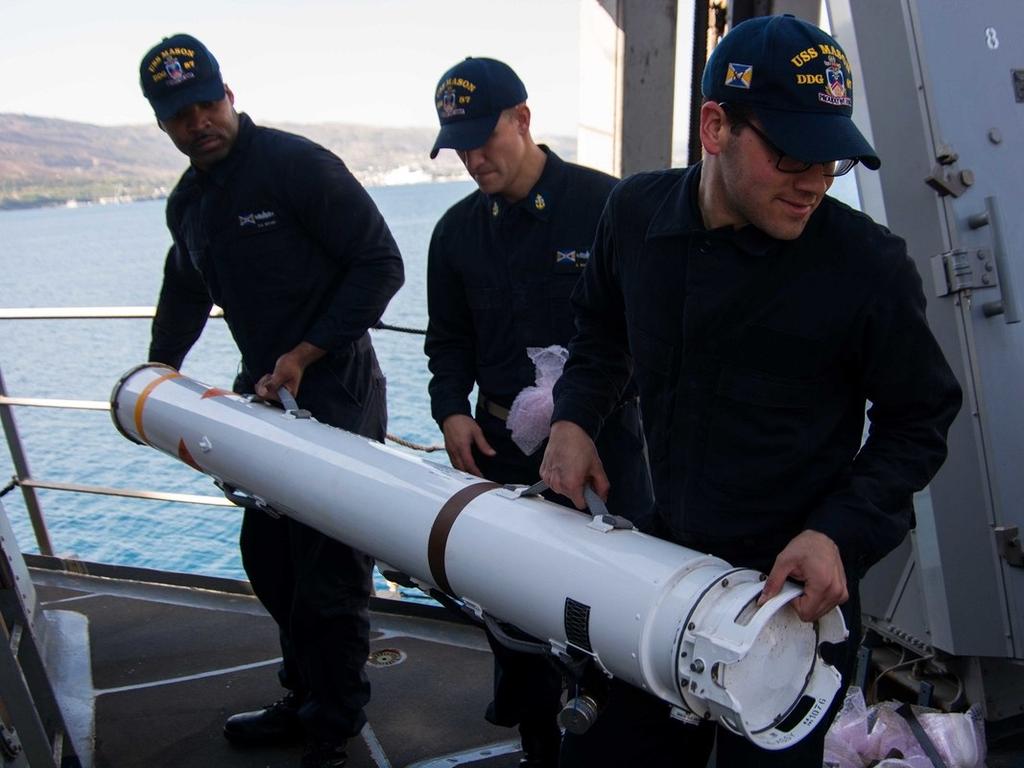 Sailors aboard the destroyer USS Mason load the Nulka missile decoy system a few days after the crew successfully shot down or diverted several missiles fired at US ships. Picture: US Navy