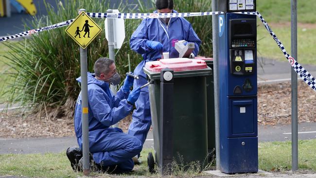 Forensic officers looking for fingerprints at the crime scene at Buffalo Creek Reserve last Wednesday. Picture: Jonathan Ng