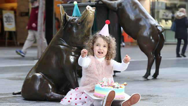 Hip, hip hooray! Attia, 2, helps the Rundle Mall pigs celebrate their 21st anniversary in the mall. Picture: Tait Schmaal.