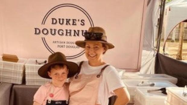 Sally Miller with Beau helping out at their Port Douglas market stall. Picture: Supplied