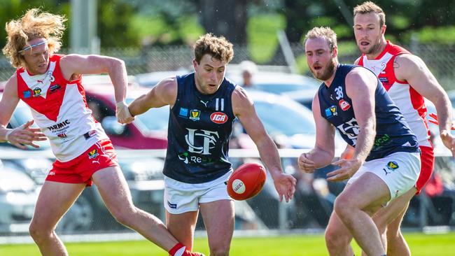 Clarence’s Ethan Jackson, left, tries to stop Launceston’s Jobi Harper from gaining possession as Launceston’s Joe Groenewegen and Clarence’s Wade Wall look on. Picture: SOLSTICE DIGITAL