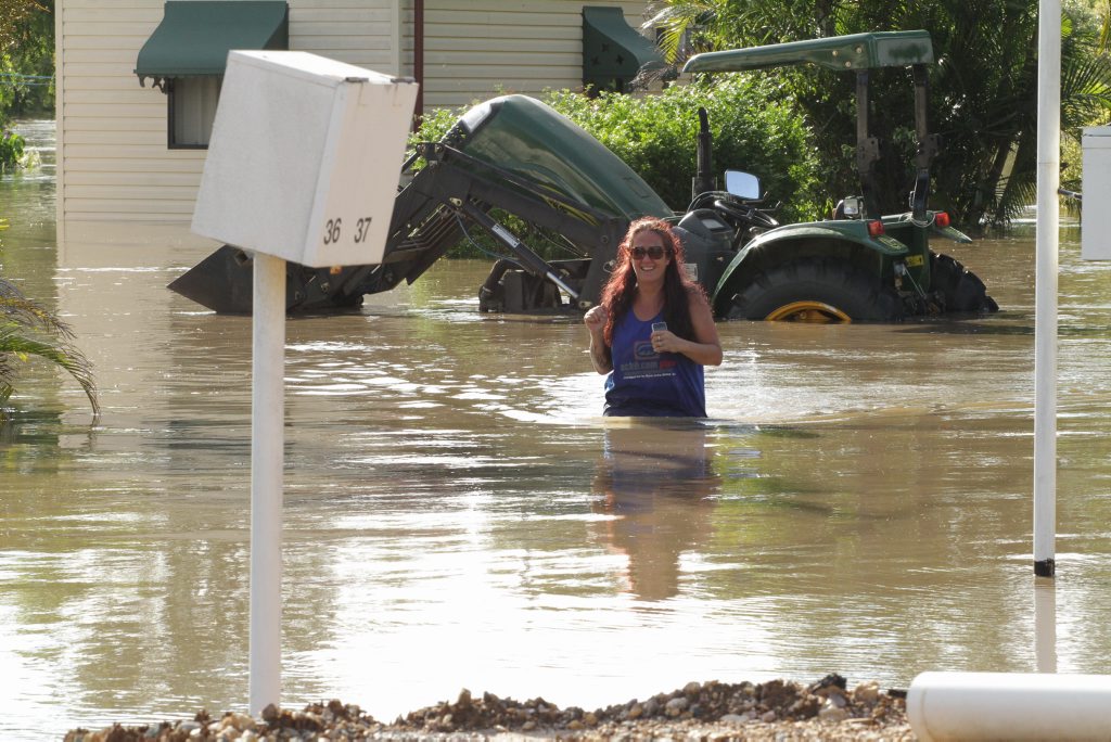 Wallace Caravan Park and Motel day manager Cherie Markham wades through the Mary River that is slowly flooding the caravan park. Photo: Robyne Cuerel / Fraser Coast Chronicle. Picture: Robyne Cuerel