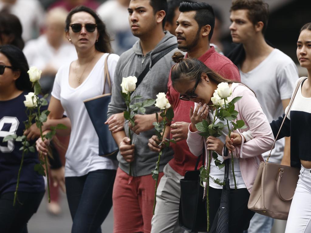 20. Hostage Elly Chen was joined by workmates from the Lindt Cafe as she made an emotional visit to the makeshift memorial in Martin Place. Picture: Tim Hunter