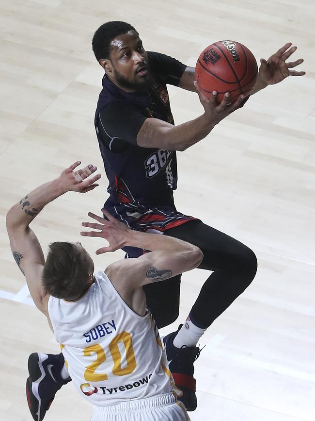 Ramone Moore drives past former 36er Nathan Sobey on Saturday. Picture SARAH REED