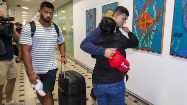 David Fifita is greeted by his mother, Gwen, after arriving home to Brisbane with Broncos teammate Payne Haas (left). Picture: AAP