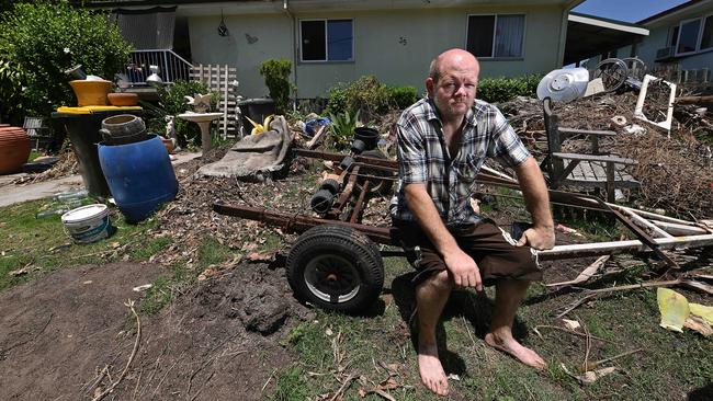 Maureen Enright’s son Kyle in the yard of their home in Polaris Street, Inala, which was searched after police were told his brother was buried there. Picture: Lyndon Mechielsen