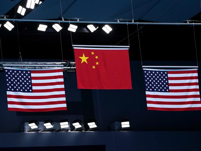 Flags raised showing a gold for China and silver and bronze for the USA at the Tokyo Olympics. Picture: Getty Images