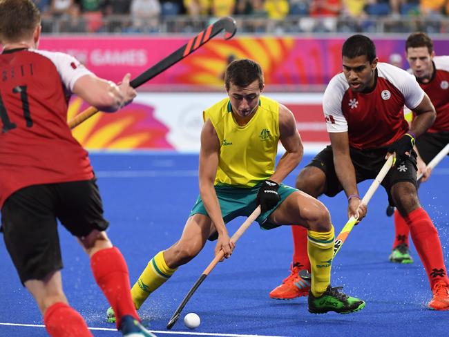 Lachlan Sharp (C) of Australia controls the ball during the men's field hockey