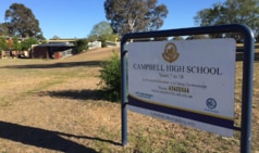 A Canberra teacher remains working despite holding a knife to a student teacher.