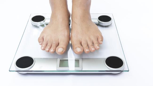 Generic photo of feet on bathroom scales. Picture: iStock