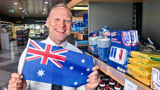 John-Paul Drake with an Australia Day flag in his Wayville store – he says he’s proud to support the national celebration. Picture: Brenton Edwards