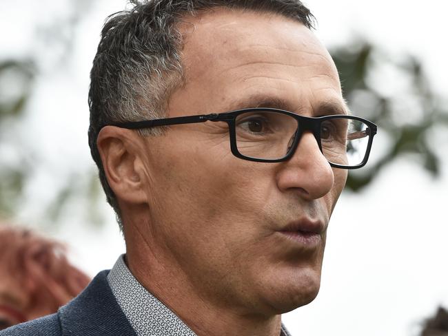 Australian Greens leader Richard Di Natale (centre) addresses the media at a press conference at the St Kilda Botanical Gardens in Melbourne, Saturday, April 13, 2019. Australian Greens leader Richard Di Natale has spoken to the media on currant affairs prior to  campaigning in the seat of Macnamara with party candidate Steph Hodgins-May. (AAP Image/James Ross) NO ARCHIVING